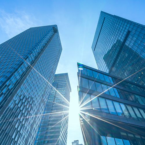 Creative image of businesspeople working together on abstract city office background with daylight and forex chart. Teamwork, trade, stock and finance concept. Double exposure
